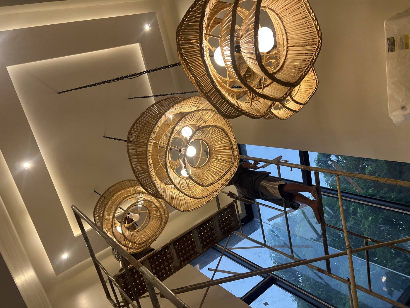 Artisan installing rattan pendants