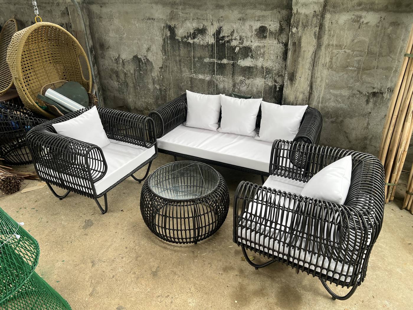 Black rattan sofa white cushions