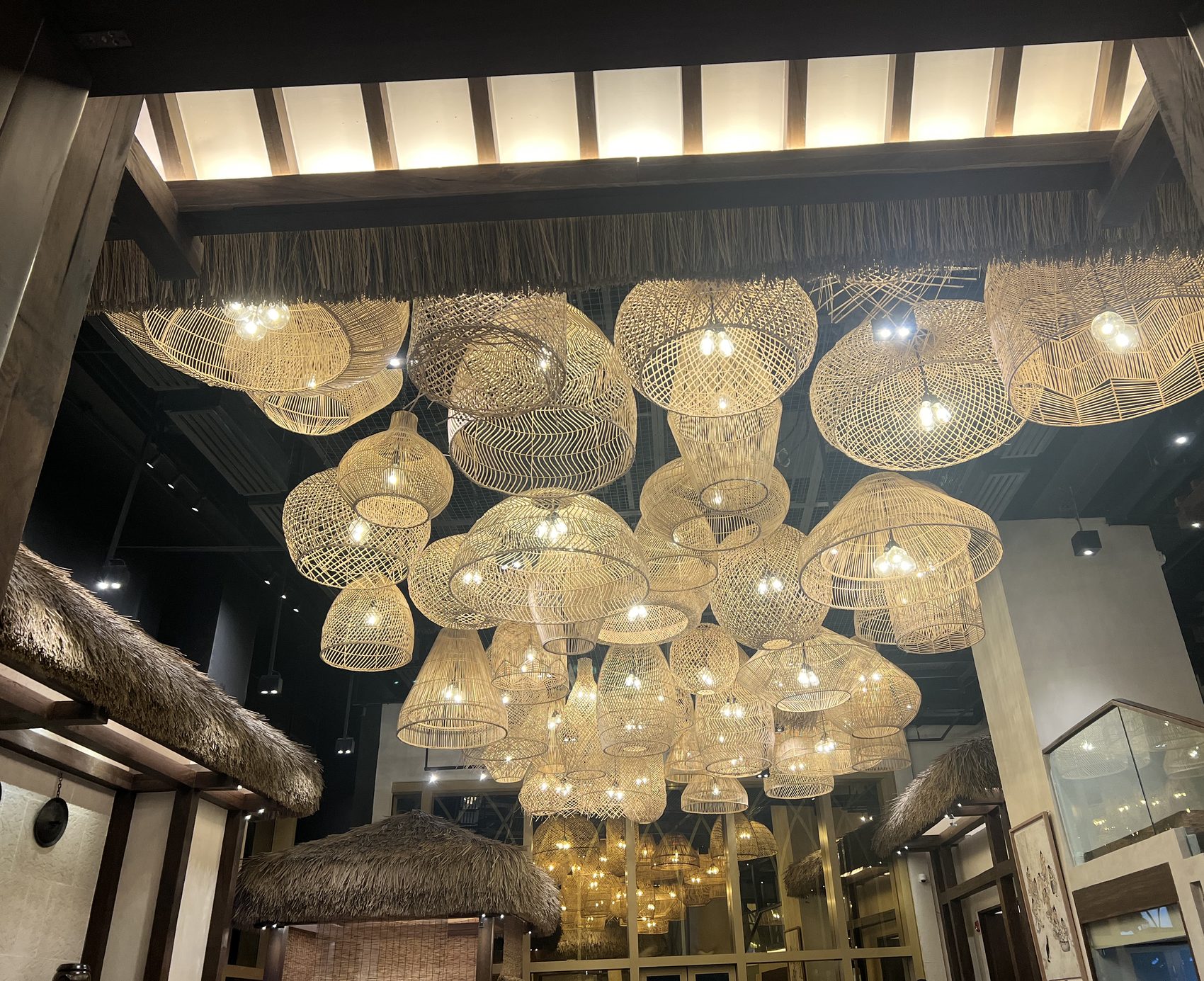 Suspended cluster of handwoven rattan pendant shades at different heights above the An Sim Jae restaurant entrance, Okada Manila